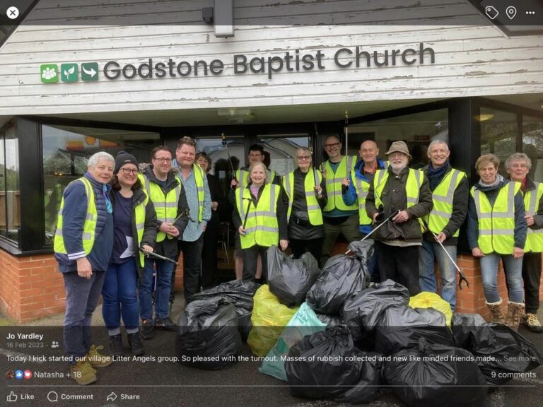 A group of litter pickers in high-vis vests outside Godstone Baptist Church