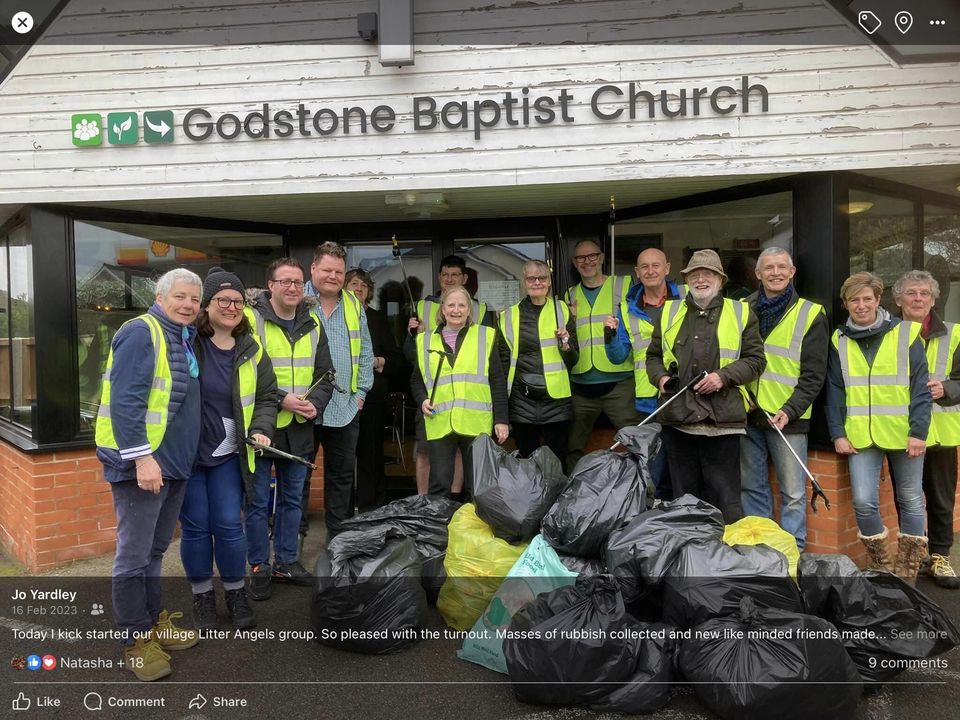 A group of litter pickers in high-vis vests outside Godstone Baptist Church