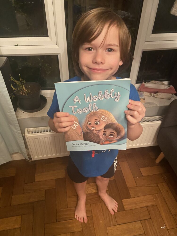 Laurence, 6, with the book A Wobbly Tooth by Janice Akhtar
