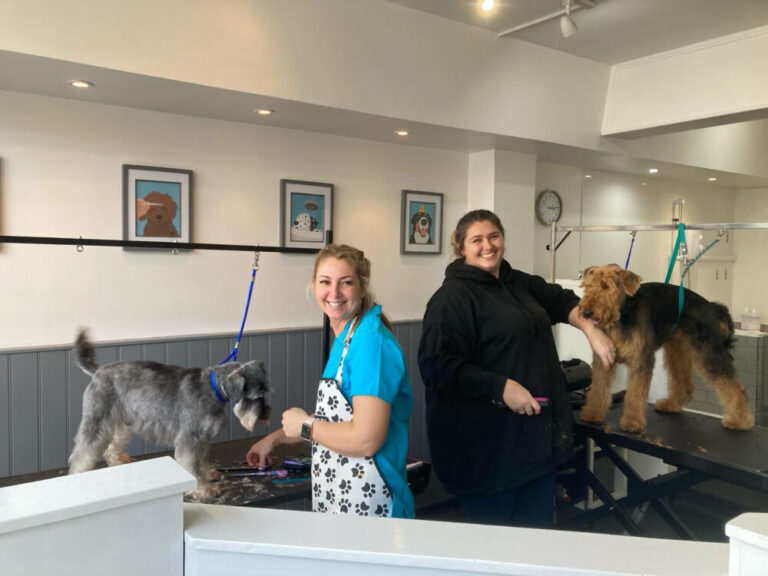 Beky and Michelle with dogs in their salon
